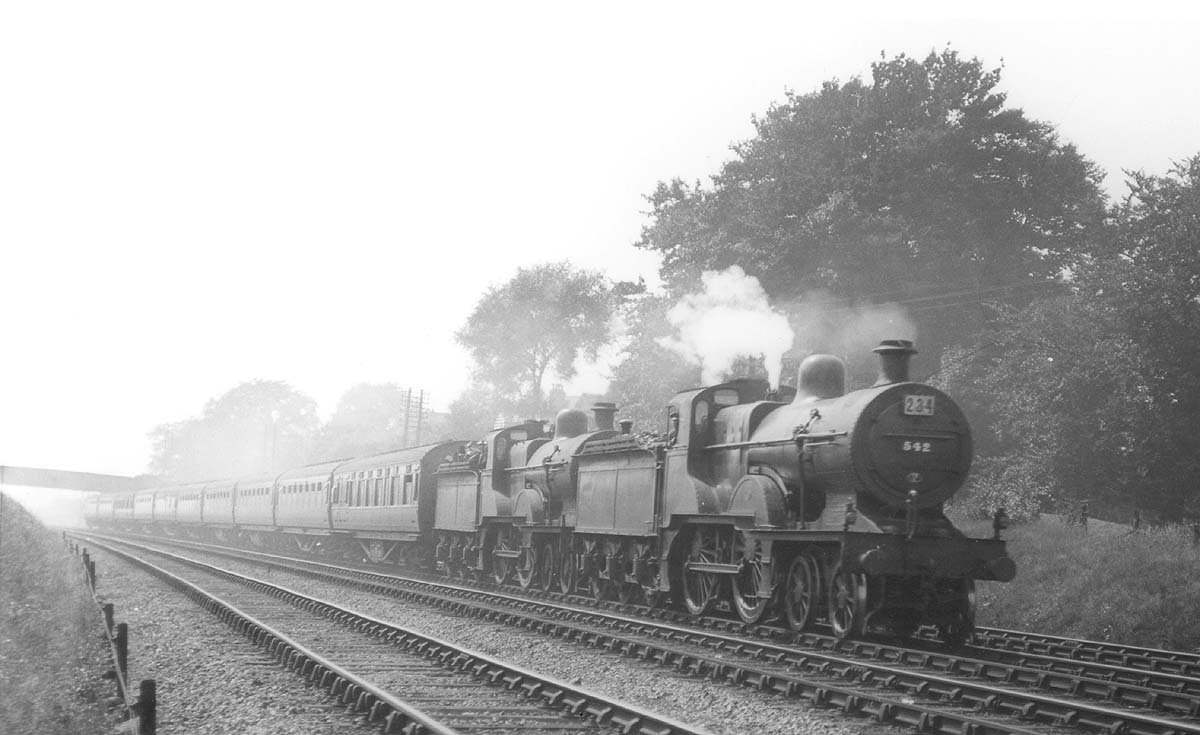 A pair of ex-MR 4-4-0s 483 class locomotives, No 542 and No 402, work an excursion south of Kings Norton in 1937