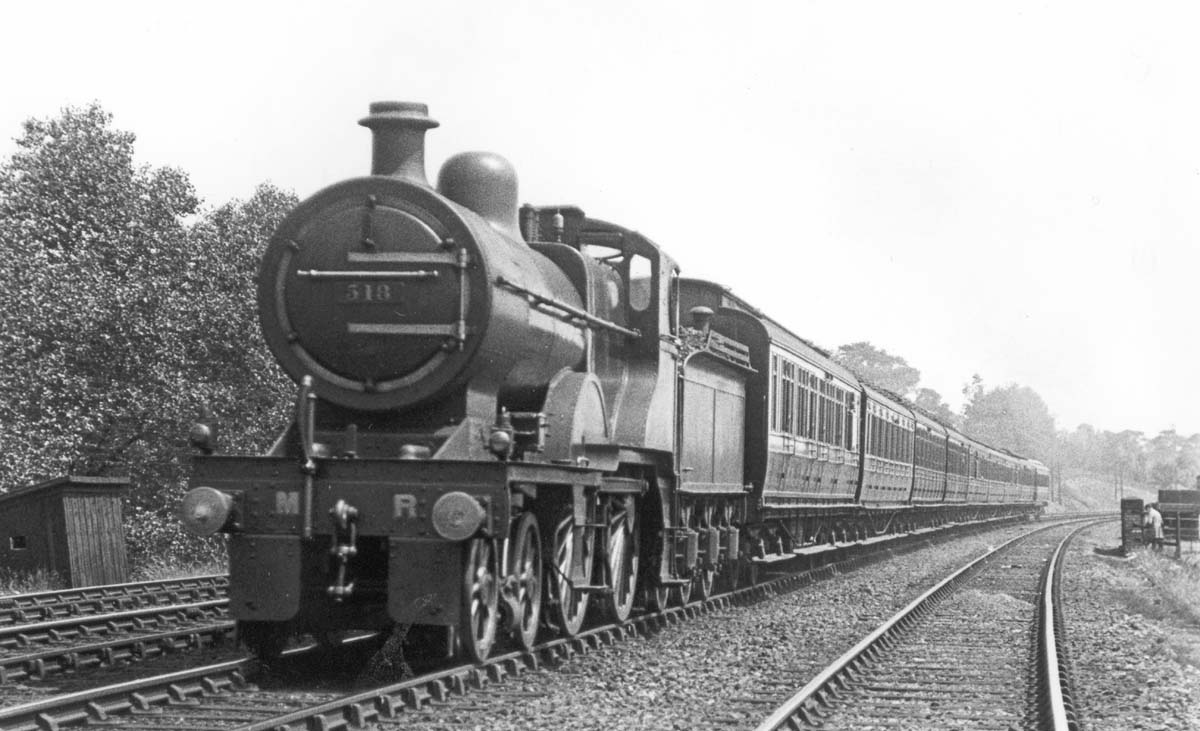 MR 4-4-0 2P No 518 is seen at the head of an express service near Kings Norton station on 9th July 1921