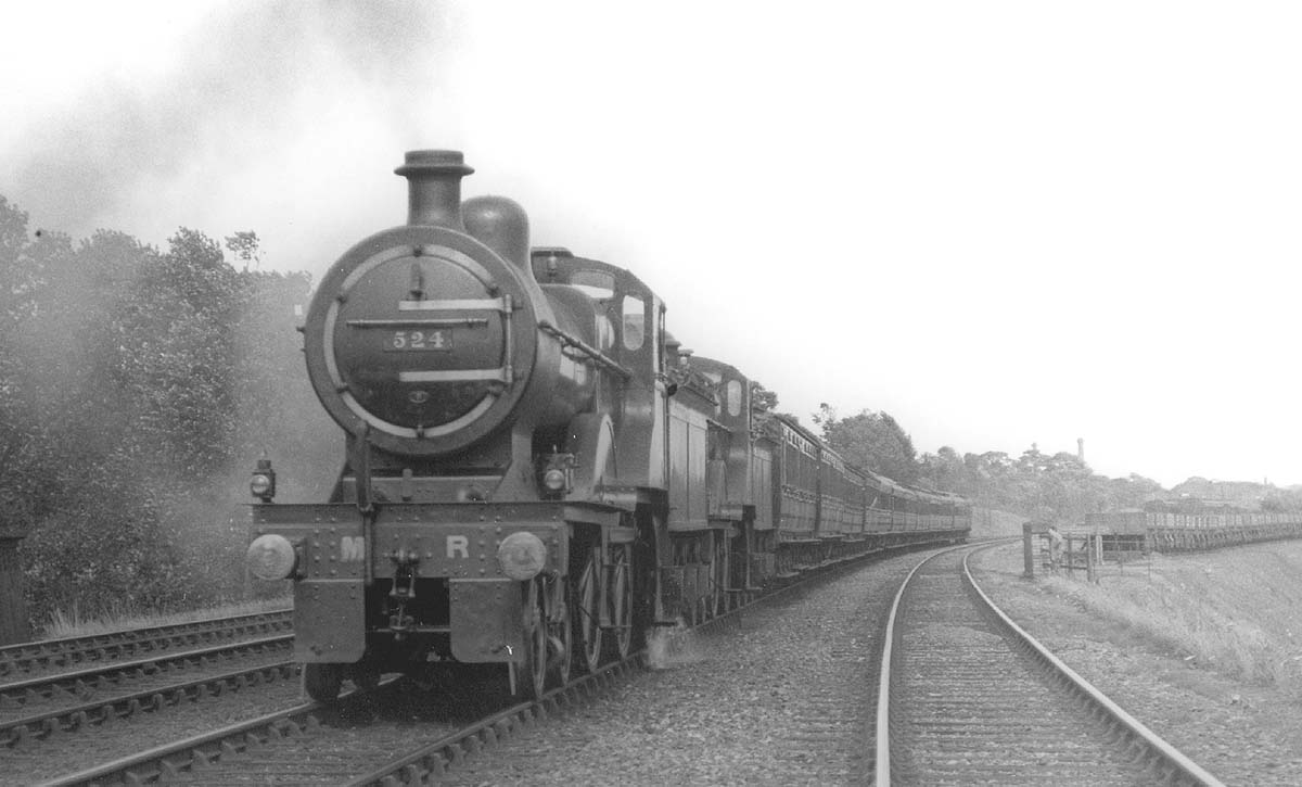 MR 4-4-0 No 524 doubleheads class mate MR 4-4-0 No 521 on a down express train as it passes the carriage sidings