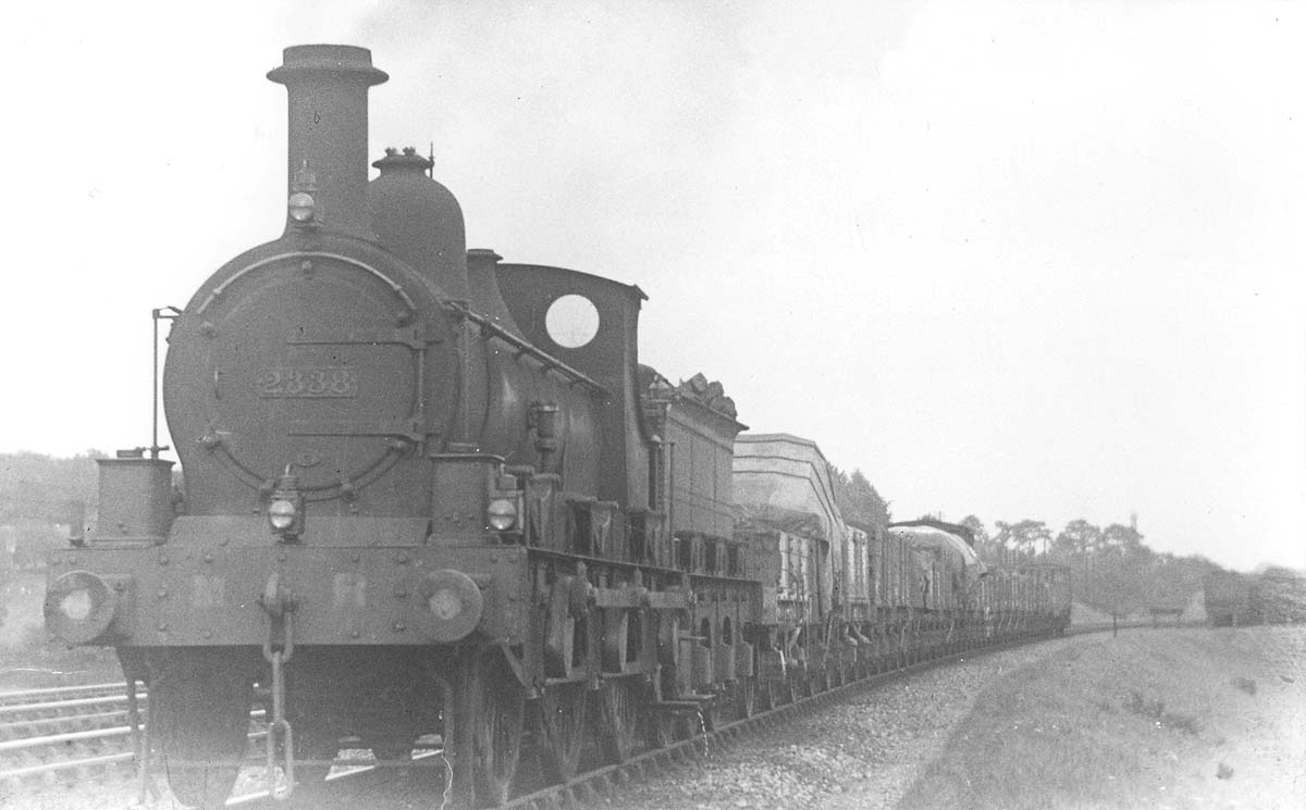 MR 0-6-0 No 2338 is seen coasting along whilst at the head of a mixed goods train comprising open wagons