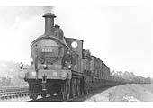 MR 0-6-0 No 3063 heads a long goods train of mainly open wagons but with fitted vans behind the tender