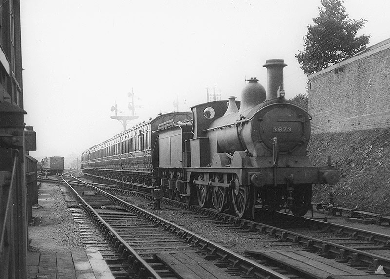 MR 0-6-0 No 3673 is seen at the head of a train of close-coupled suburban coaching stock as it enters the station