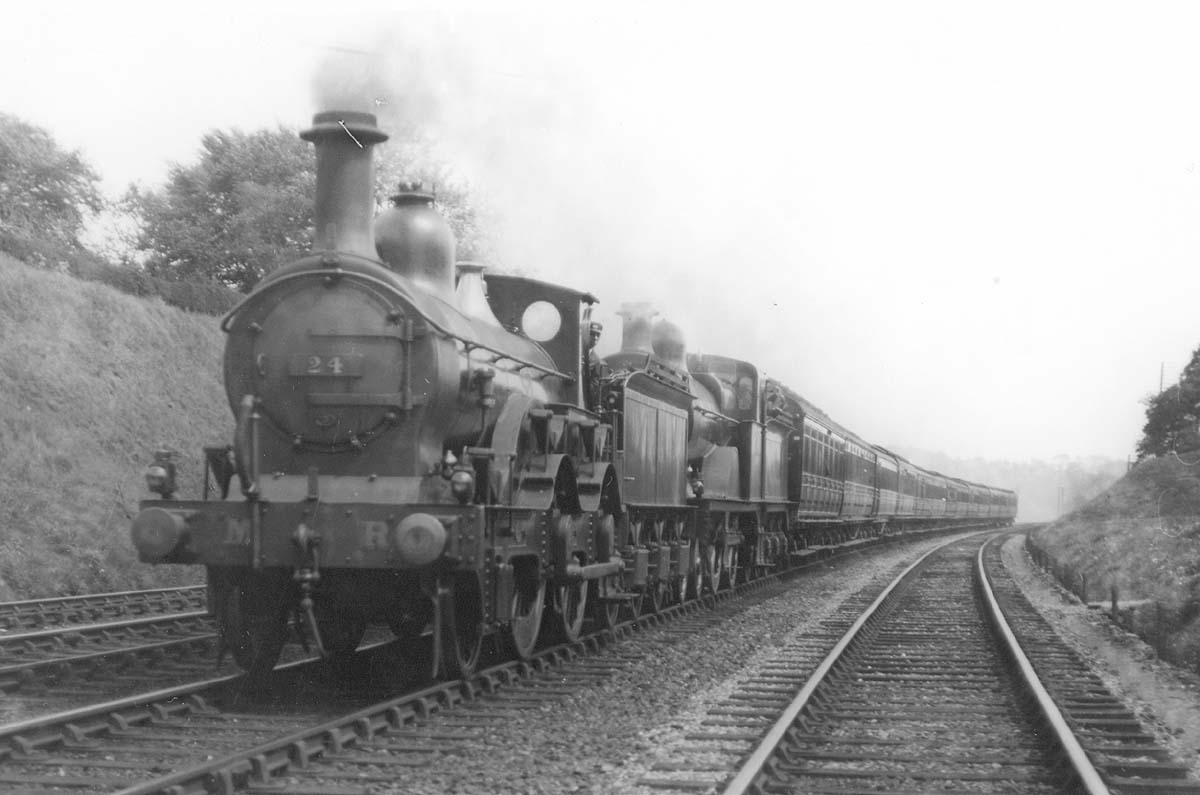 MR Kirtley 1P 2-4-0 No 24 pilots MR 4-4-0 2P No 778 on a down express south of Kings Norton in 1921