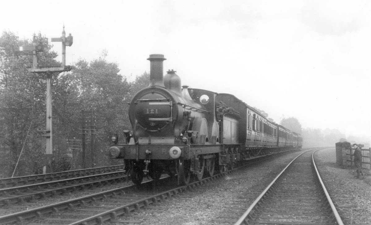 MR Kirtley 1P 2-4-0 No 121, a Saltley shed locomotive, is seen at the head of a down express south of Kings Norton