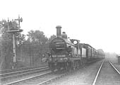 MR 2-4-0 No 206, a Bournville engine, is seen at the head of a local passenger train south of Kings Norton station