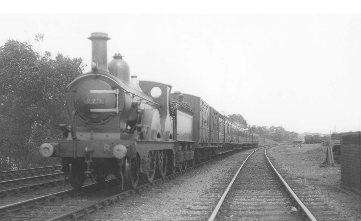 MR 2-4-0 No 279 with several vans behind the tender on a passenger train near Kings Norton