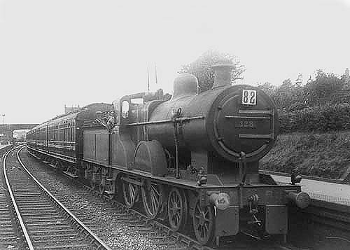MR 4-4-0 2P No 328 is seen heading a holiday special made up of clerestory coaches through the original Kings Norton station
