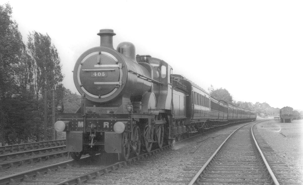 MR 4-4-0 No 405 sports a number 3 Saltley shed plate as it works an express train south of Kings Norton