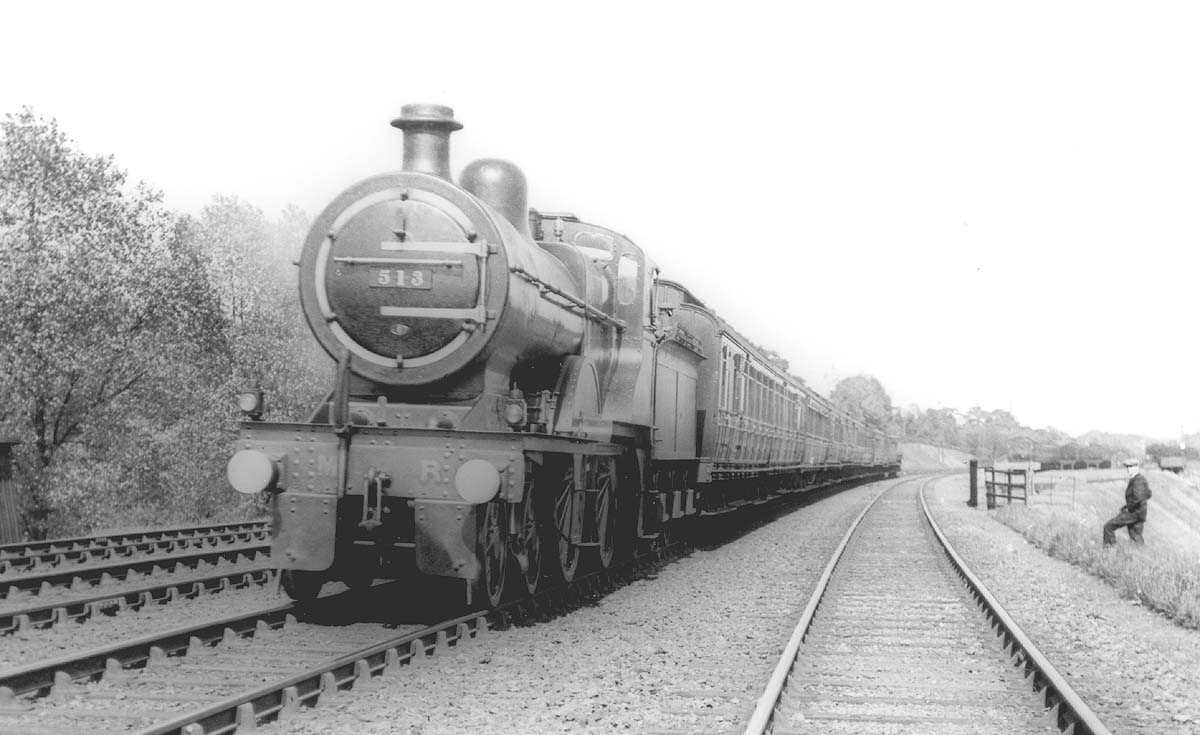 MR 4-4-0 No 513 on an express whilst in the distance above the photographer's colleague can be seen the carriage sidings