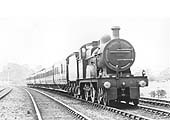 MR 4-4-0 3P No 710 is at the head of an express service as it passes the Permanent Way gang's lineside hut on 16th July 1921