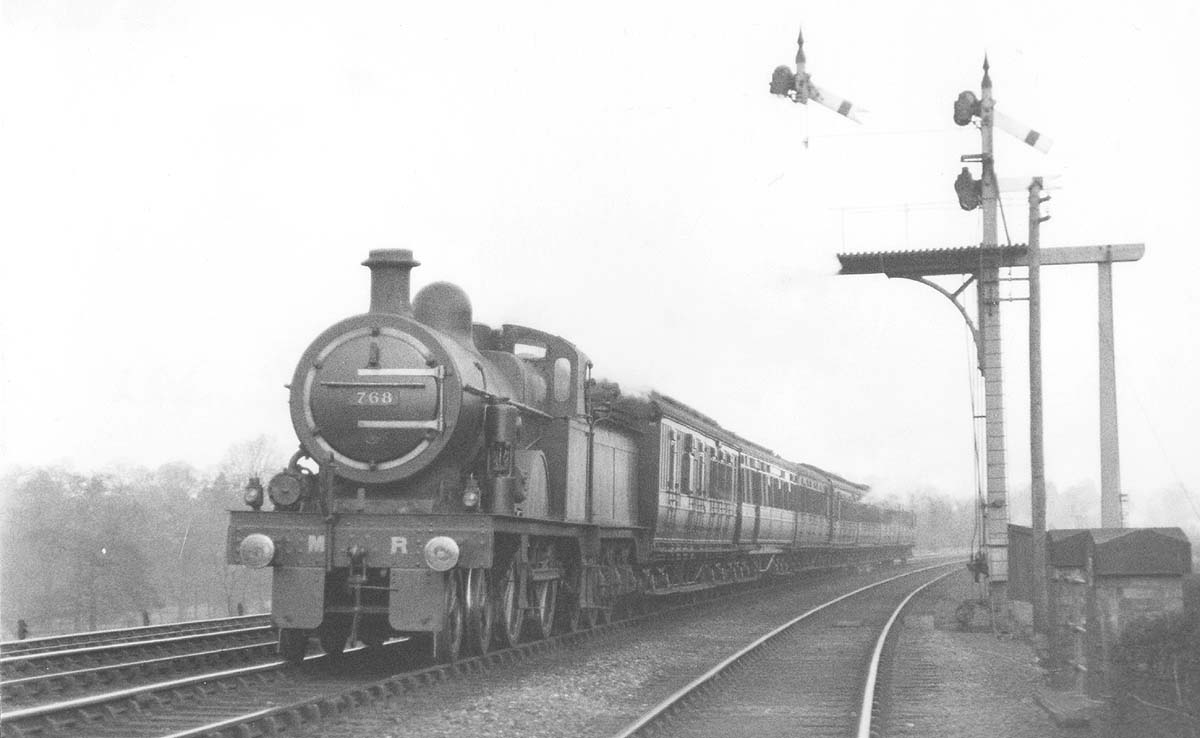 MR 4-4-0 3P No 768 is passing the MR signal gantry south of the carriage sidings whilst at the head of a down express service in March 1922