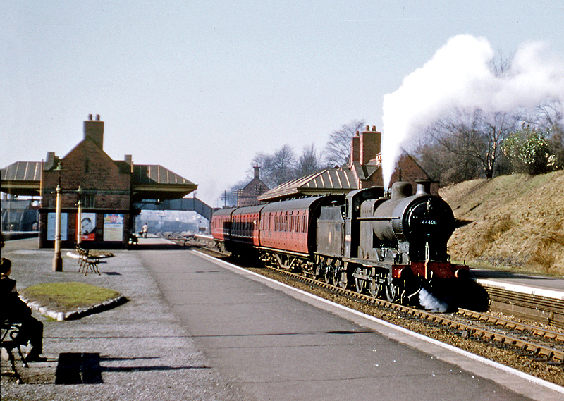 Ex-LMS 4F 0-6-0 No 44406 blows off as it departs from Kings Norton on a cloudless Spring day circa 1959-60