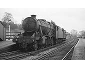 Ex-LMS 8F 2-8-0 No 48449 is passing through Kings Norton Station towing a brake van en-route to pick up a goods train