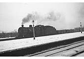 Ex-LMS 0-6-0 4F No 44605 is passing Kings Norton Station with a mineral train for Washwood Heath on a snowy winter's day