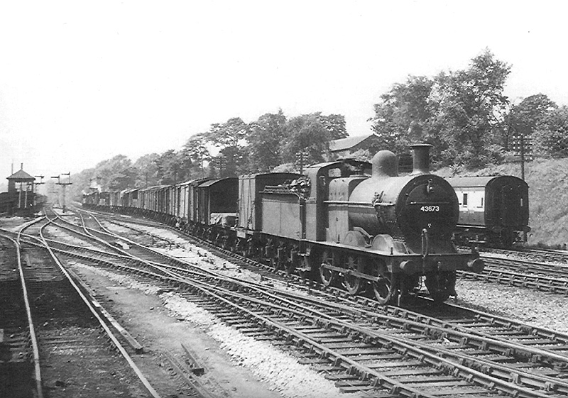 Ex-MR 0-6-0 3F No 43673, at the head of an up Class F express freight train, crosses over to the Camp Hill up line in 1953