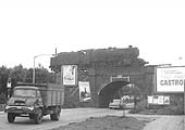 Ex-LMS 8F 2-8-0 No 48713 runs light engine tender first over the A444 on its way to pick up its train in Abbey Street sidings in early 1966