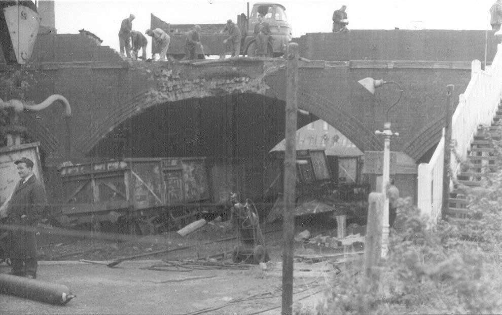 Workmen clear the debris of the bridge carrying the Midland Road over the railway on 18th November 1968