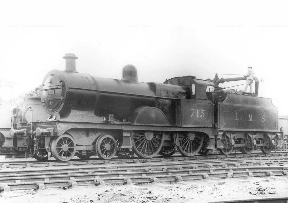 Ex-MR 3P 4-4-0 No 715, a member of the MR's 2606 class, is seen with the fireman topping up the tender's tank on 2nd June 1935