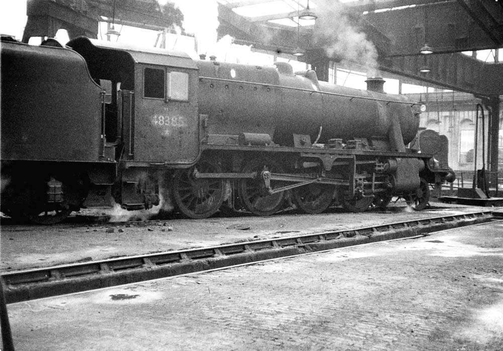 Ex-LMS 8F 2-8-0 No 48385 is seen blowing off steam inside No 3 roundhouse at Saltley shed