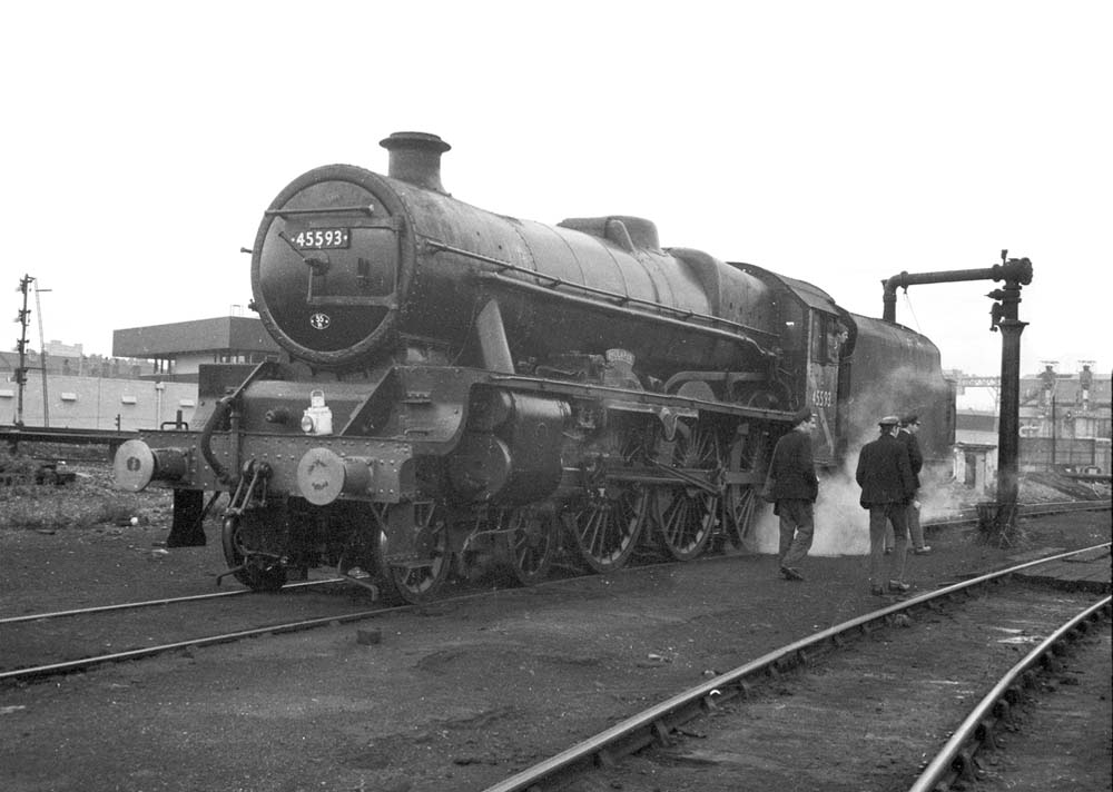 Ex-LMS 5XP 4-6-0 No 45593 'Kolaphur', a Jubilee class locomotive, is taking on water at  Saltley en route to Tyseley