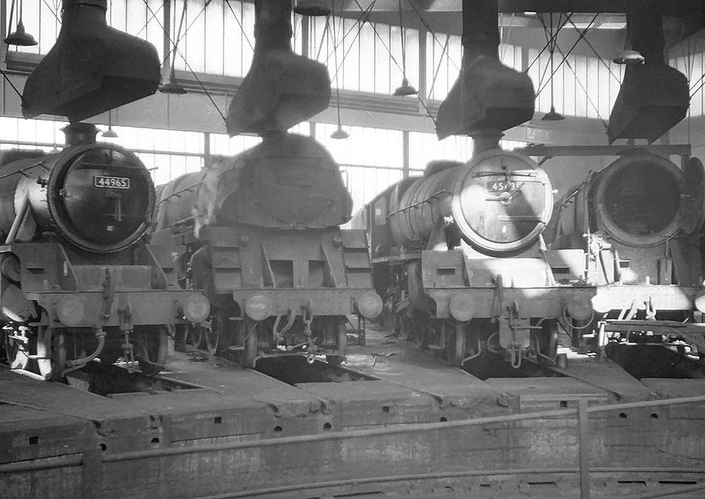 BR Standard and ex-LMS locomotives, including 5MT 4-6-0 No 44965, stand inside one of Saltley's roundhouses on 25th March 1964