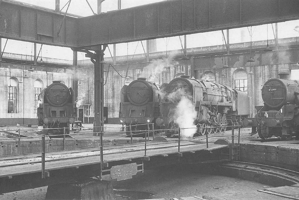 General view inside Saltley No 3 roundhouse with three BR Standard Class 9F 2-10-0 locomotives on view