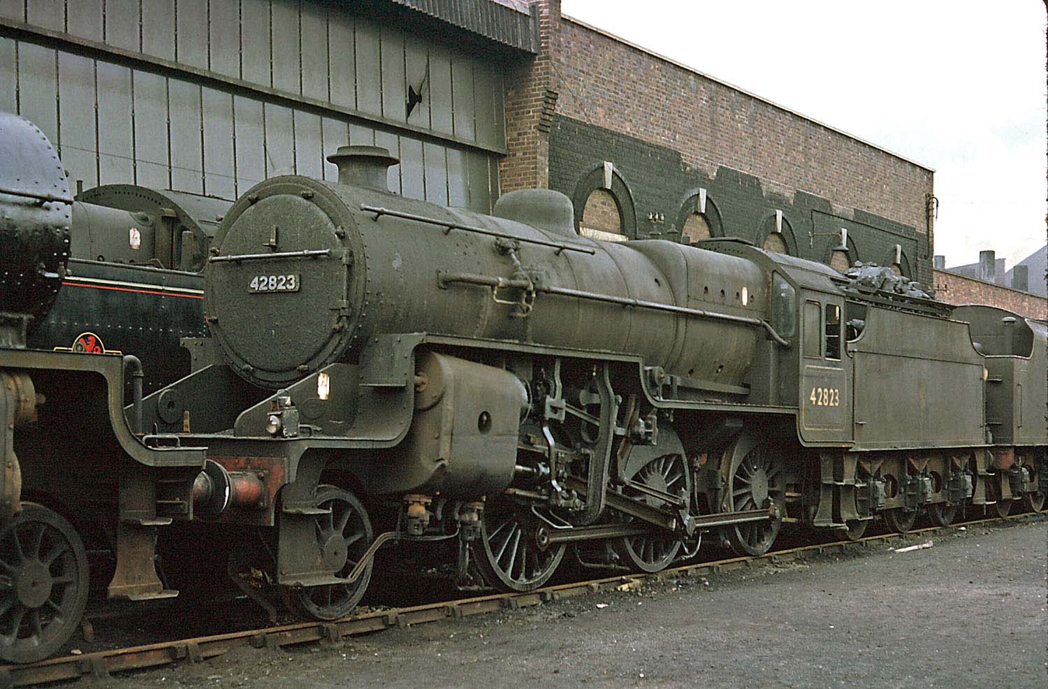 Ex LMS 2-6-0 No 42823, is seen standing on the back roads behind Saltley Number 3 shed in March 1962
