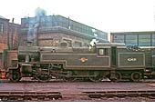 A broadside view of ex LMS 2-6-4T No 42421, standing in front of the offices, with water tank above, at Saltley shed