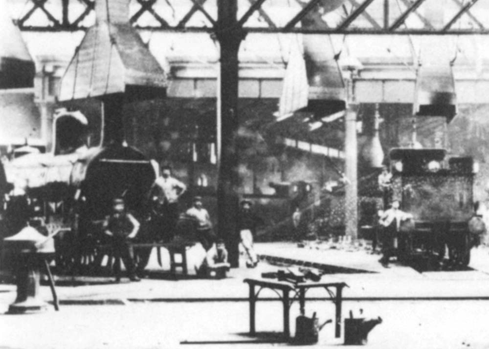 Close up showing one of the Sharp Stewart 2-2-2 locomotives positioned under a smoke hood and the hand-operated capstan for turning the turntable seen on the left