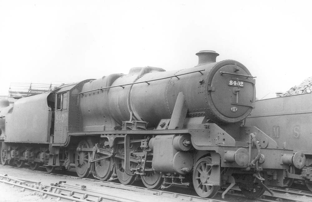LMS 8F 2-8-0 No 8402 is seen standing 'cold' in line with other engines on the stabling roads outside Saltley shed's No 3 roundhouse