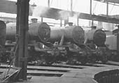 An internal view of one of Saltley shed's rebuilt roundhouses with two ex-LMS 8Fs, a BR Standard 9F and an ex-LMS Black 5 on show around the turntable