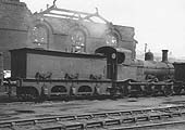 Ex-MR 2F 0-6-0 No 22853, a MR 700 class locomotive, is seen standing adjacent to the war time damaged corner of Saltley shed's No 3 roundhouse