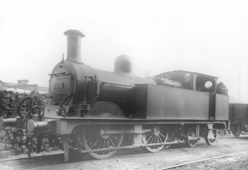 Ex-MR 1P 0-4-4T No 1348 is seen standing on the stabling roads in front of No 3 roundhouse next to one of Saltley's many coal stacks