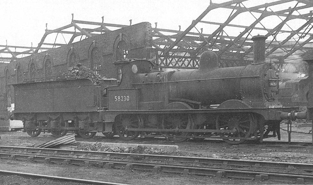 Ex-MR Johnson 2F 0-6-0 No 58230 stands outside Saltley Shed's roundhouse during rebuilding on Sunday 9th October 1955