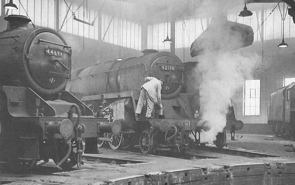 BR Standard 9F 2-10-0 No 92138 and BR built 5MT 4-6-0 No 44691 stand around one of the roundhouses on Sunday 22nd November 1964