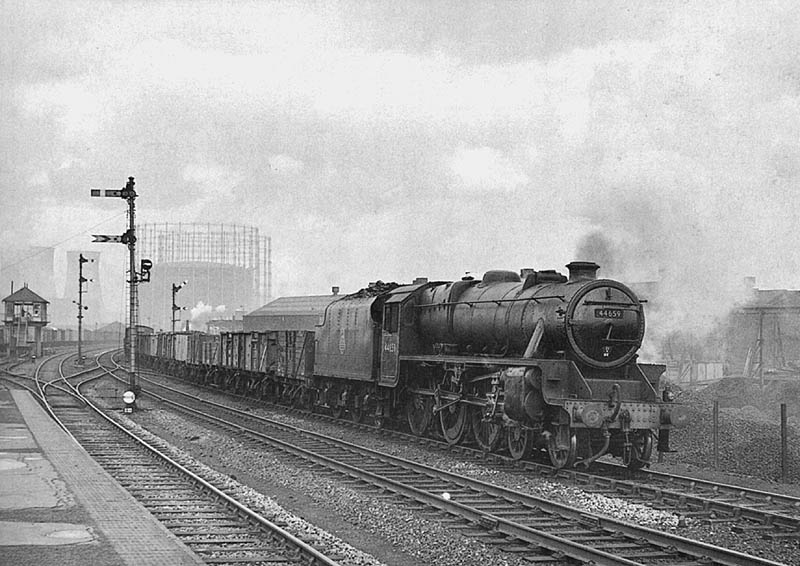 British Railways built 5MT 4-6-0 No 44659 passes the station on a down freight being banked by Johnson 3F 0-6-0 No 43693