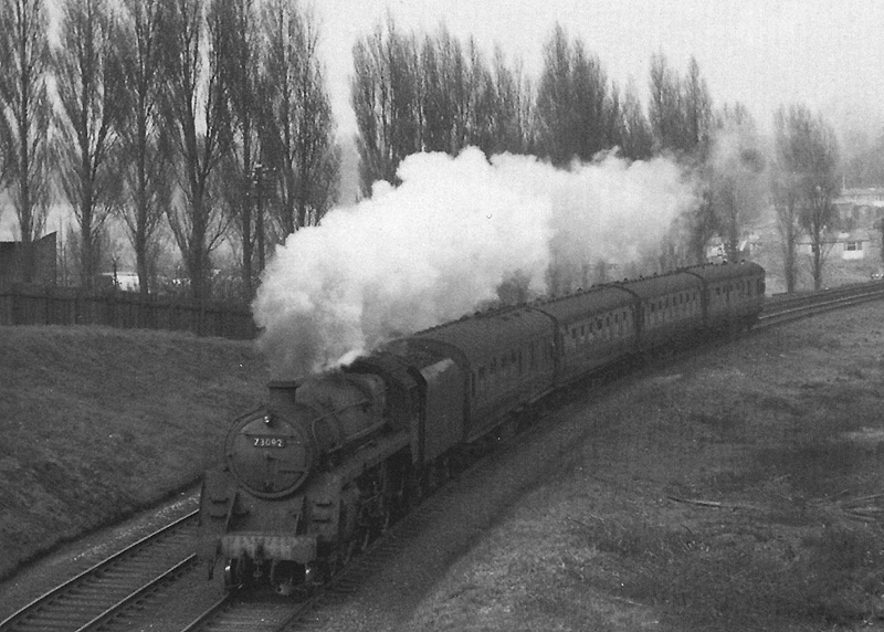 British Railways 4-6-0 Standard Class 5 No 73092 is seen on a down four coach express service from New Street to Worcester in 1963