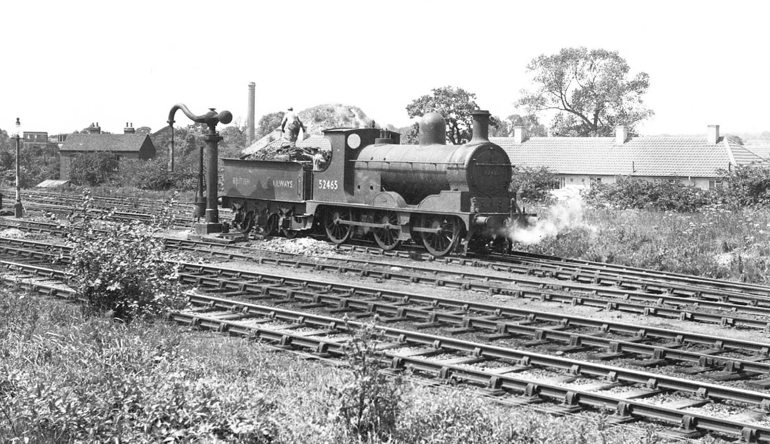 Ex-L&Y 0-6-0 No 52465 stands by the water crane during shunting duties in Stockingford marshalling yard circa 1950