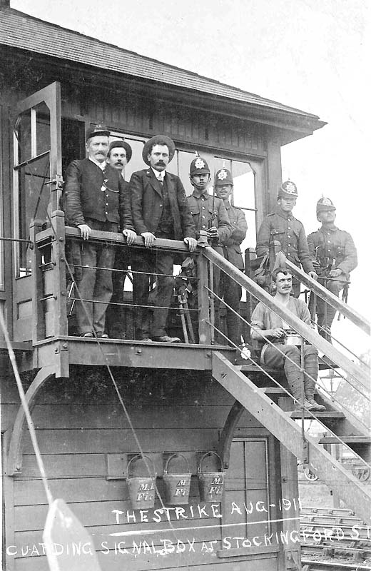 Non-striking railway staff pose with soldiers of the 1st Dorset Regiment outside Stockingford Sidings Signal Box in 1911