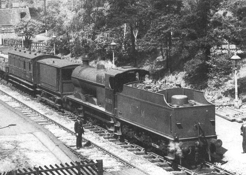 Close up showing LMS 4F 0-6-0 No 4069 coupled to a Midland Brake Van and six-wheel coach