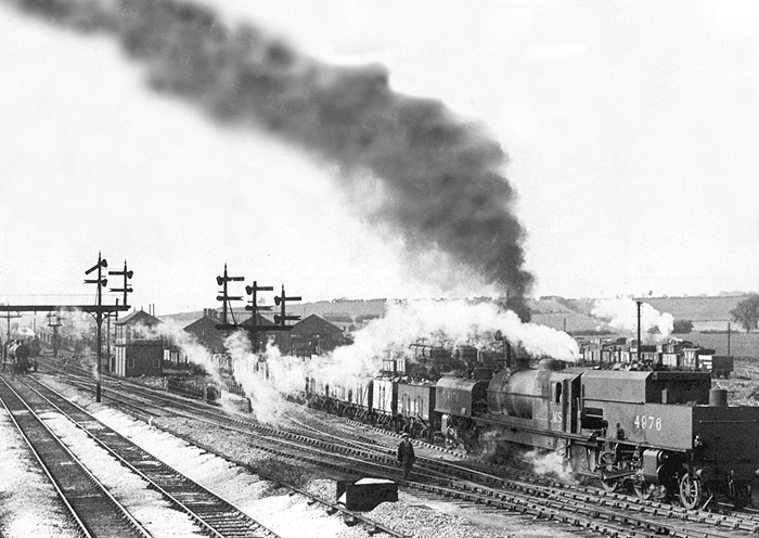 LMS 2-6-0+0-6-2 Beyer Peacock No 4976 is seen running bunker first at the head of a long coal train at Washwood Heath Sidings