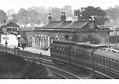 Close up showing the station building with signalbox located on the platform and footbridge to the opposite platform