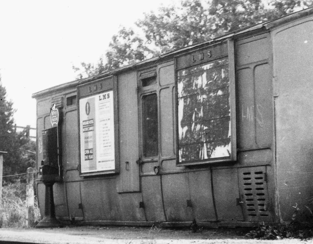 Close up   showing the grounded six-wheel coach body  used as a passenger waiting room on Bidford on Avon station's platform