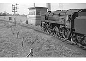 British Railways Standard Class 9F 2-10-0 No 92213 approaches Broom West Signal Box with a westbound freight service