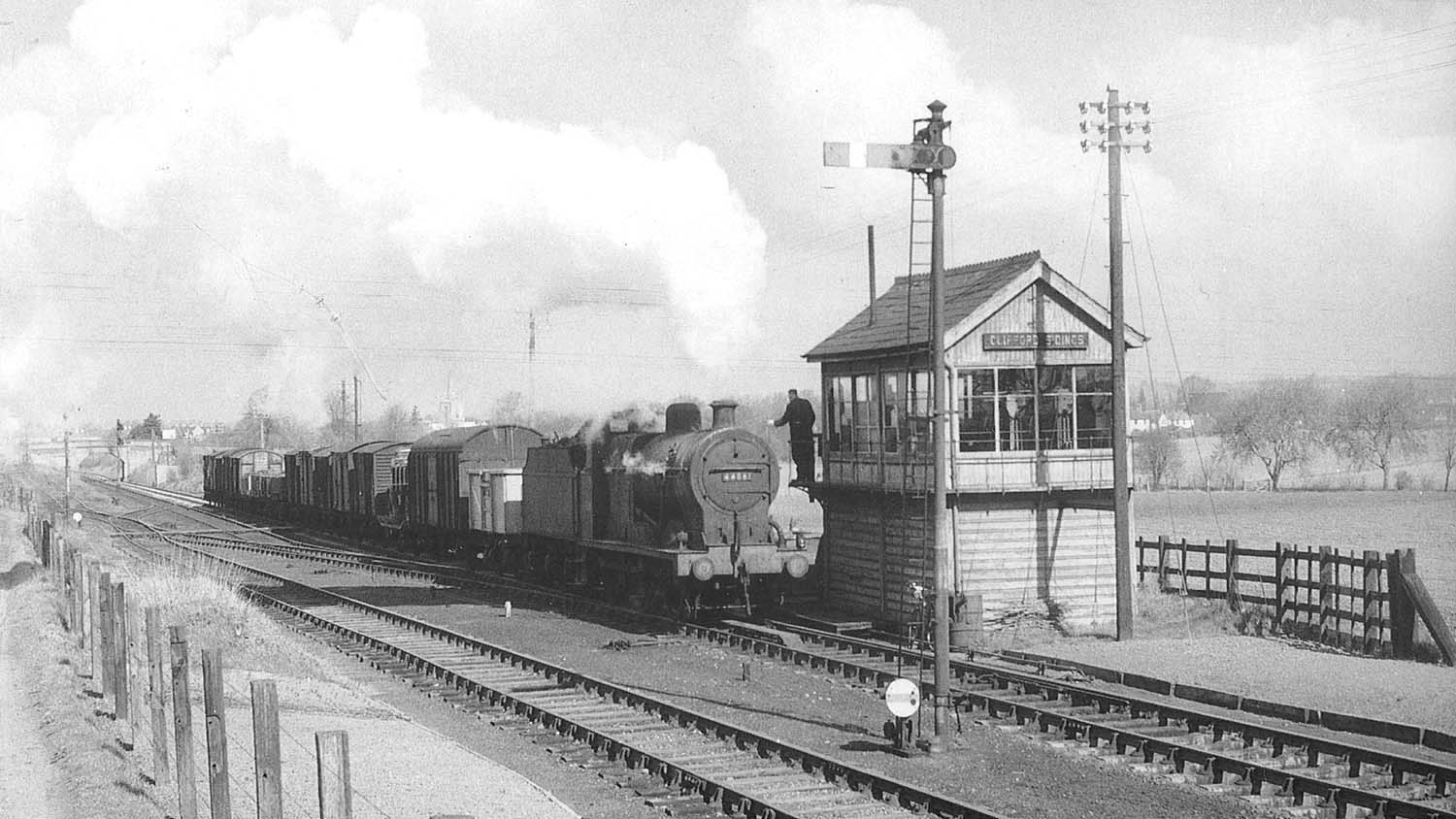 Ex-LMS 4F 0-6-0 No 44061 exchanges the token with the signalman from Clifford Sidings Signal Box