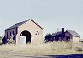 A colour view of the long abandoned goods shed and station building as seen on 17th July 1966