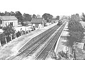 An unknown ex-LNWR 0-6-0 locomotive stands light engine at the up platform opposite the signal box