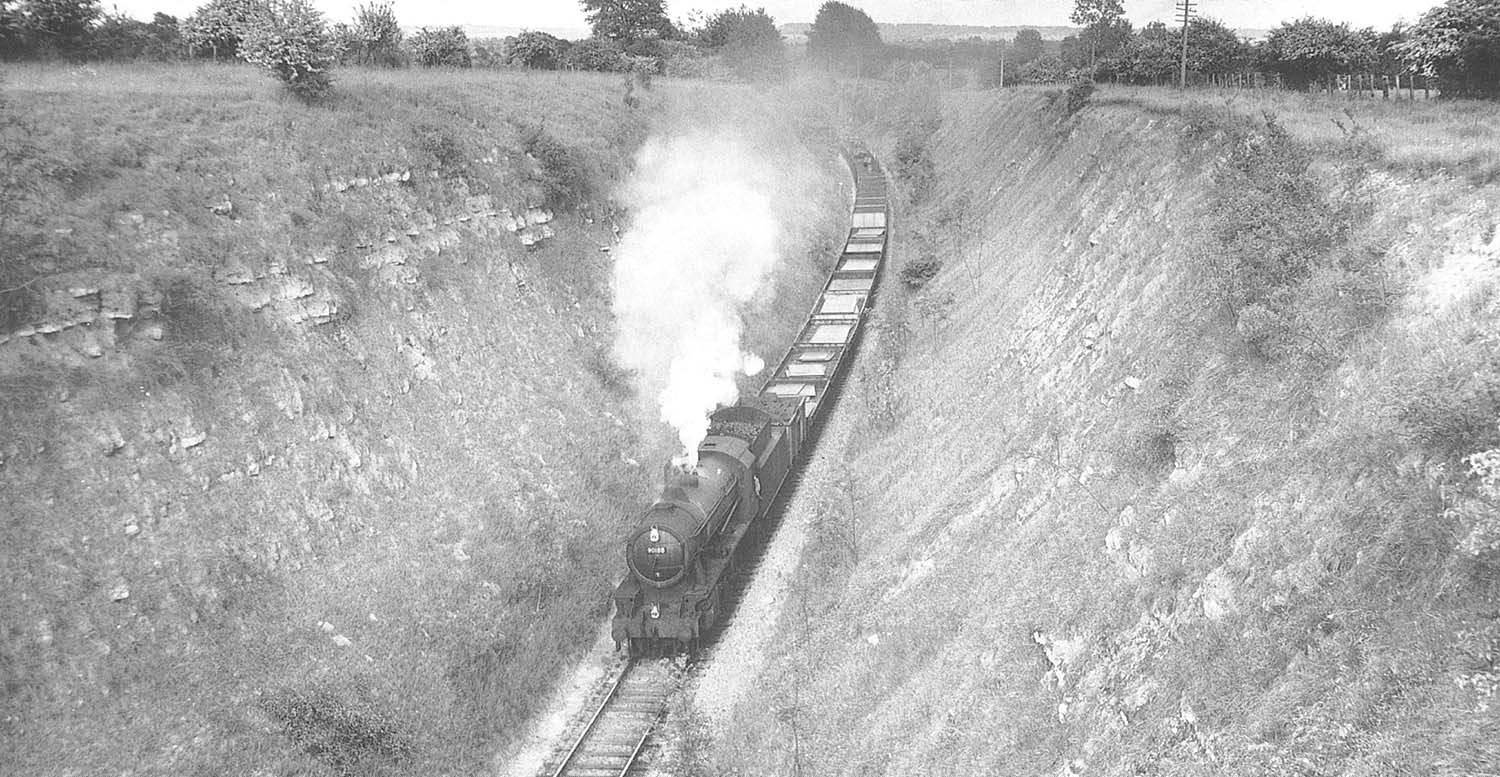Ex-WD 2-8-0 No 90188, with steam to spare, works a Class H service through Goldicott Cutting in June 1962