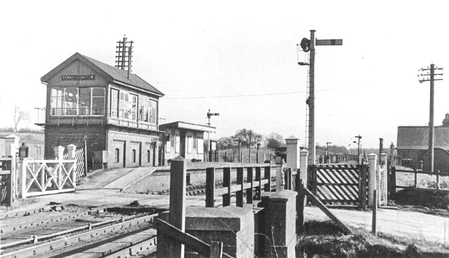 Looking across the SMJ level crossing towards the joint GWR/LMS Fenny Compton Signal Box in the Blisworth direction in March 1952