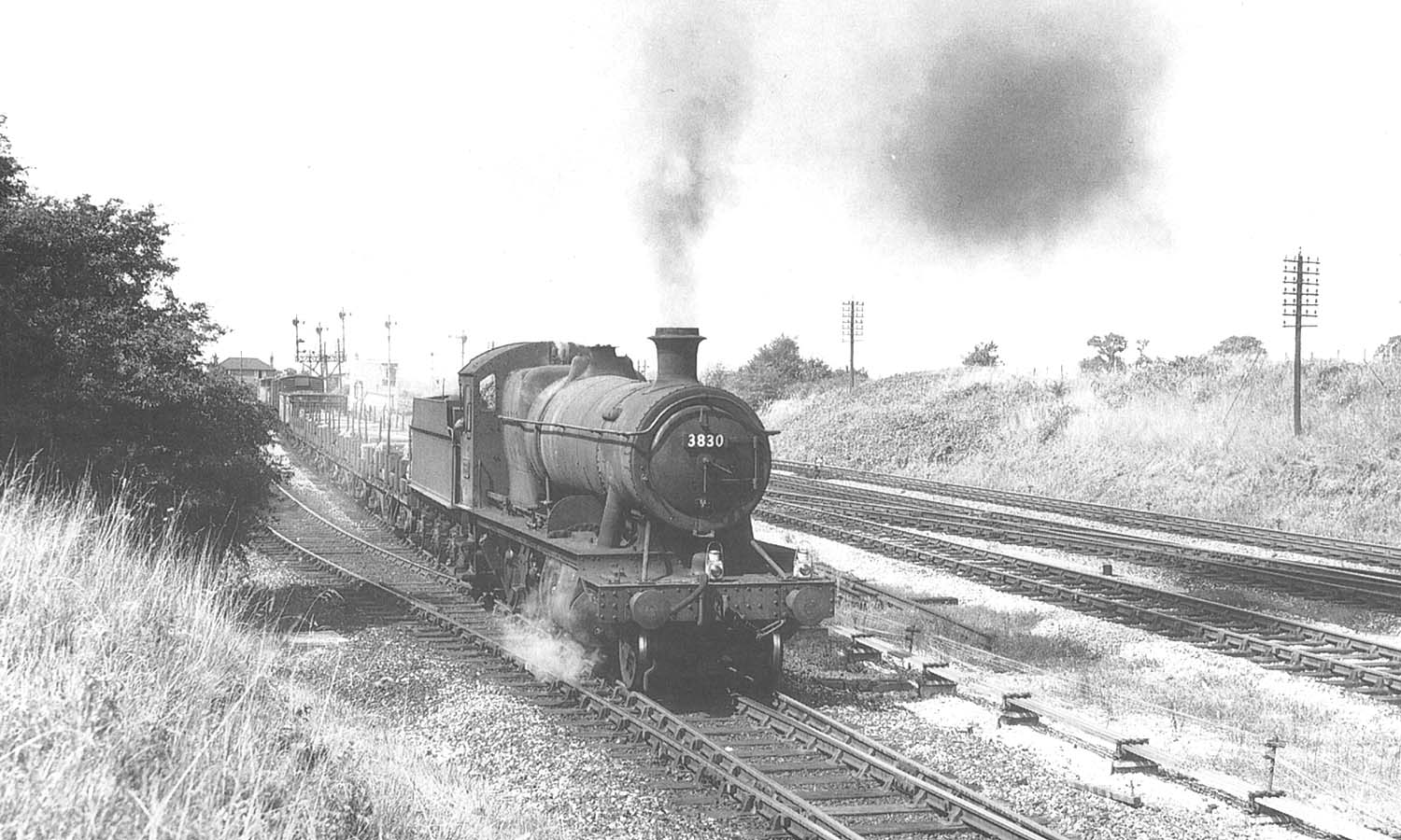 Ex-GWR 2-8-0 No 3830 is seen leaving the former Fenny Compton up platform with a goods service in 1964